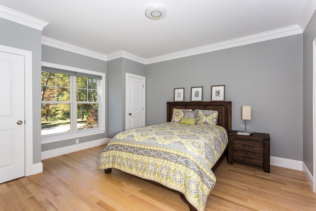 216 Oak Street Westwood, MA 02090 - Photo 15 of 37 a bedroom with a bed and a large window