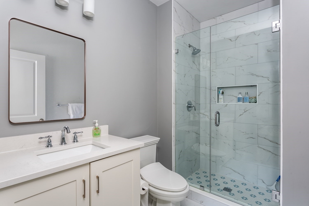 216 Oak Street Westwood, MA 02090 - Photo 16 of 37 a bathroom with a sink toilet vanity and shower