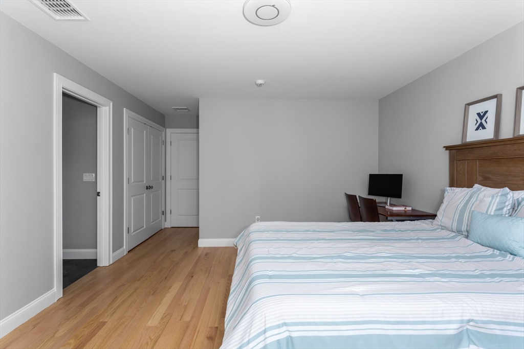 216 Oak Street Westwood, MA 02090 - Photo 27 of 37 a bedroom with a bed and wooden floor