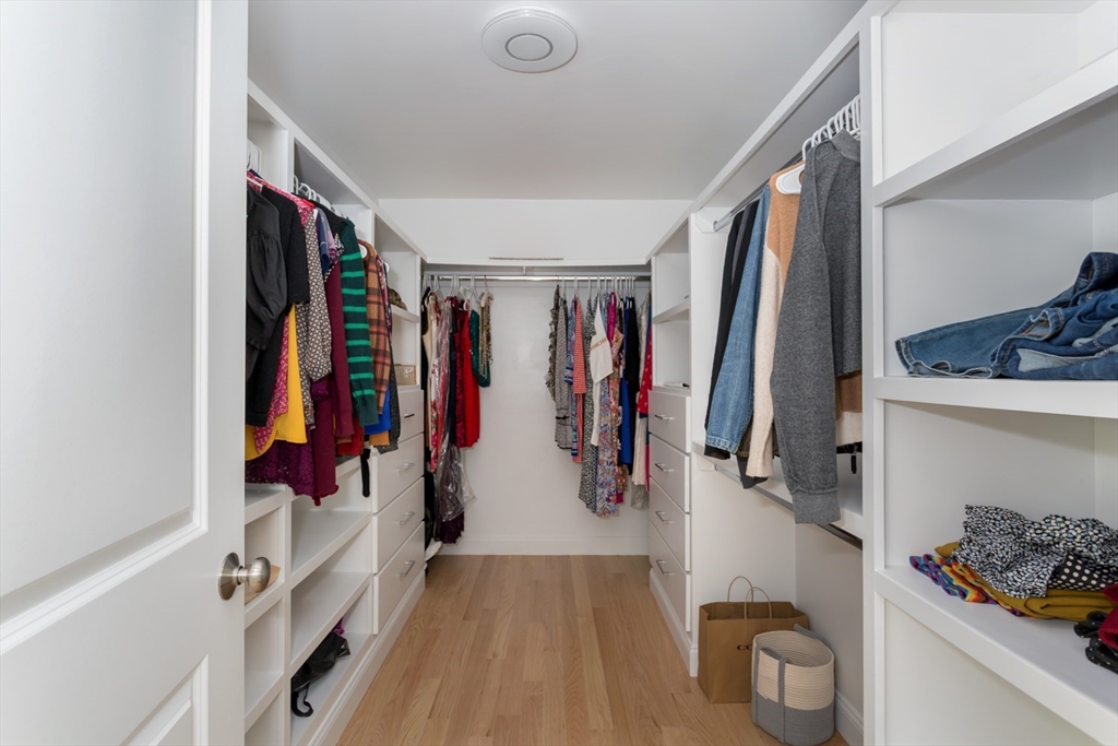 216 Oak Street Westwood, MA 02090 - Photo 28 of 37 a view of walk in closet with clothes and shoes