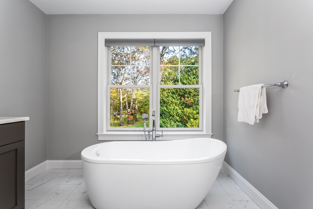 216 Oak Street Westwood, MA 02090 - Photo 30 of 37 a white bath tub sitting in a bathroom next to a window