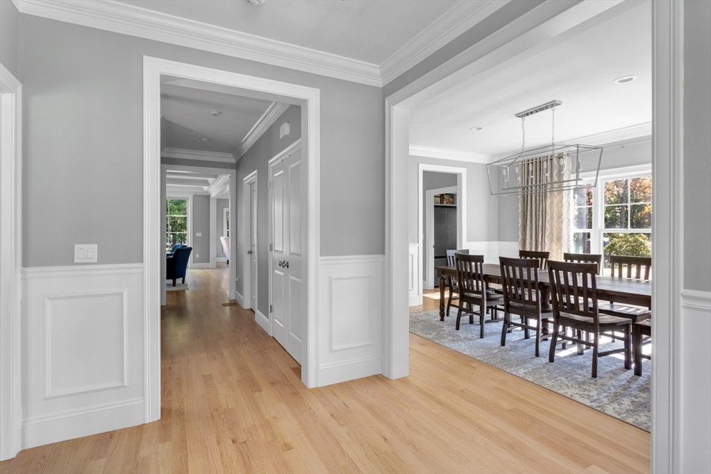 216 Oak Street Westwood, MA 02090 - Photo 9 of 37 a view of a a dining room and livingroom with furniture wooden floor a chandelier