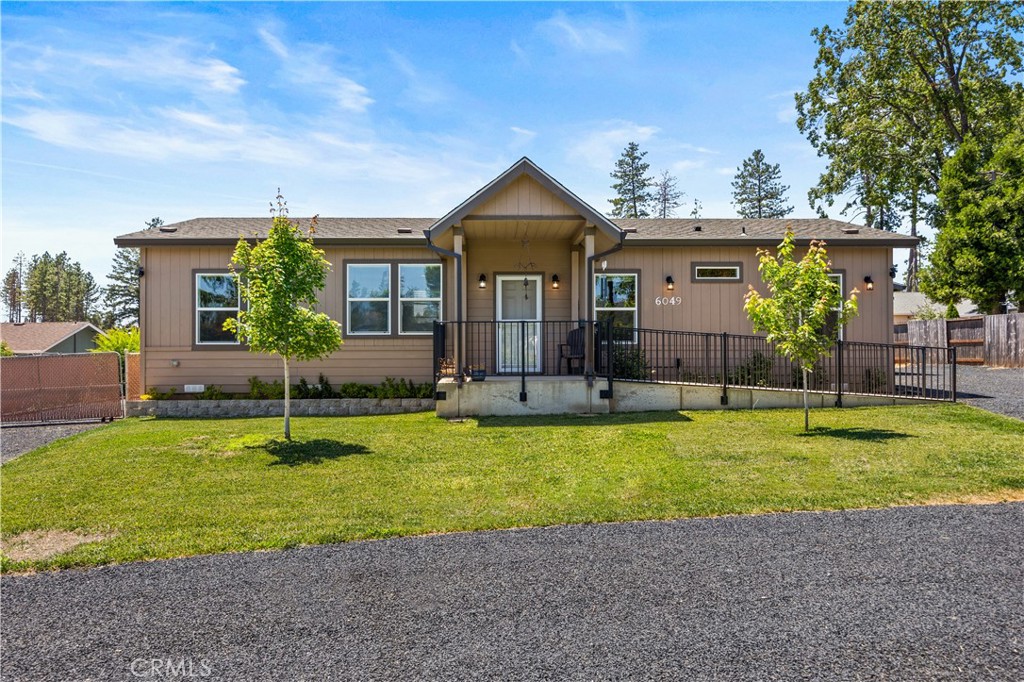 a view of a house with swimming pool and a yard