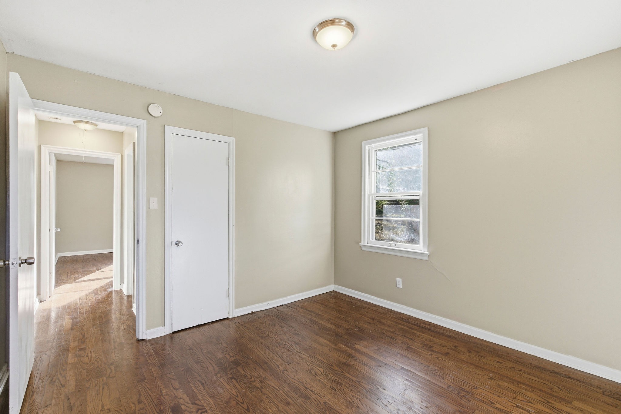705 Pace Street Gallatin, TN 37066 - Photo 15 of 21 a view of an empty room with wooden floor and a window