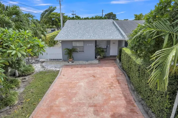 a aerial view of a house with a yard and potted plants