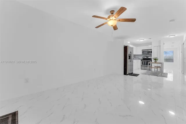 a view of a kitchen with a sink and a refrigerator