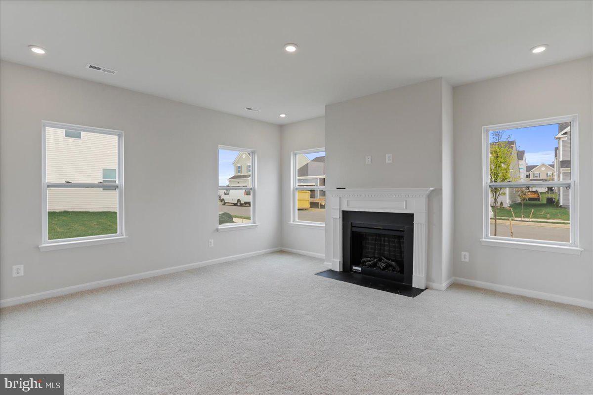 62 Peters Avenue Ranson, WV 25438 - Photo 15 of 31 an empty room with windows and fireplace