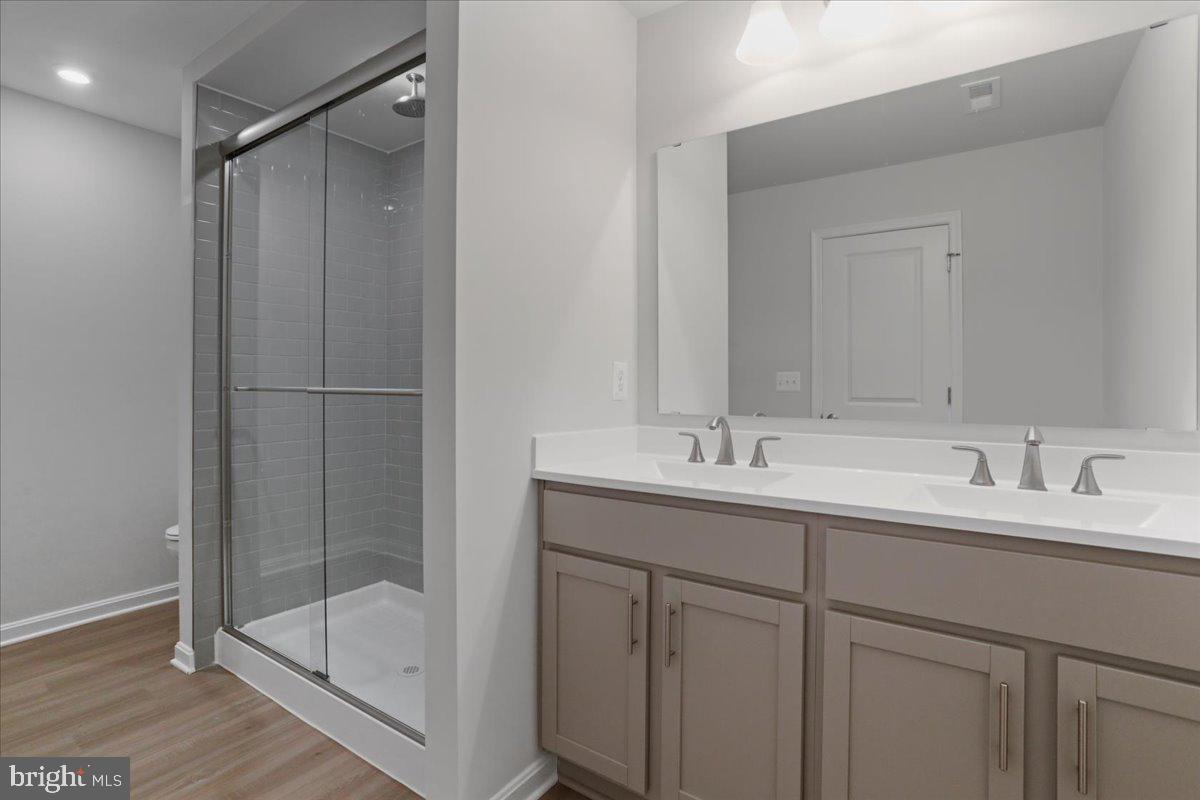 62 Peters Avenue Ranson, WV 25438 - Photo 22 of 31 a bathroom with a double vanity sink mirror and shower