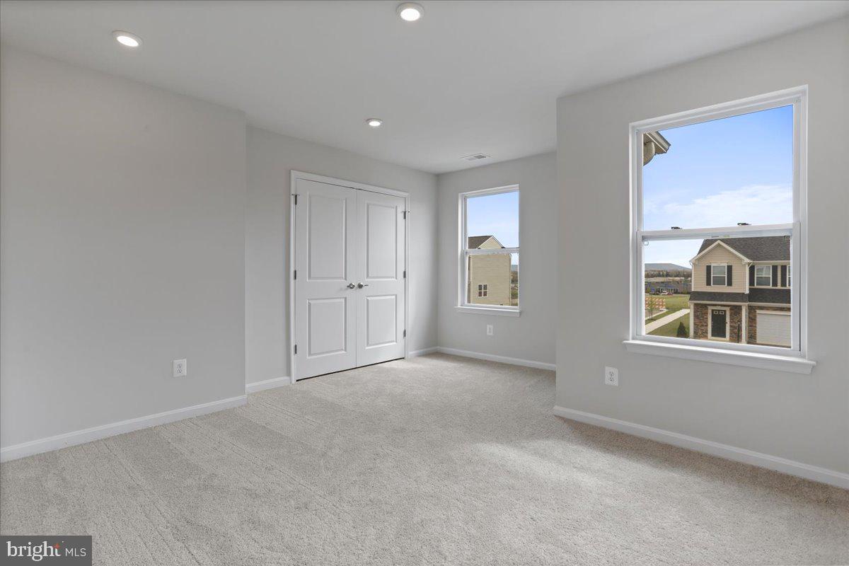 62 Peters Avenue Ranson, WV 25438 - Photo 24 of 31 an empty room with windows and closet
