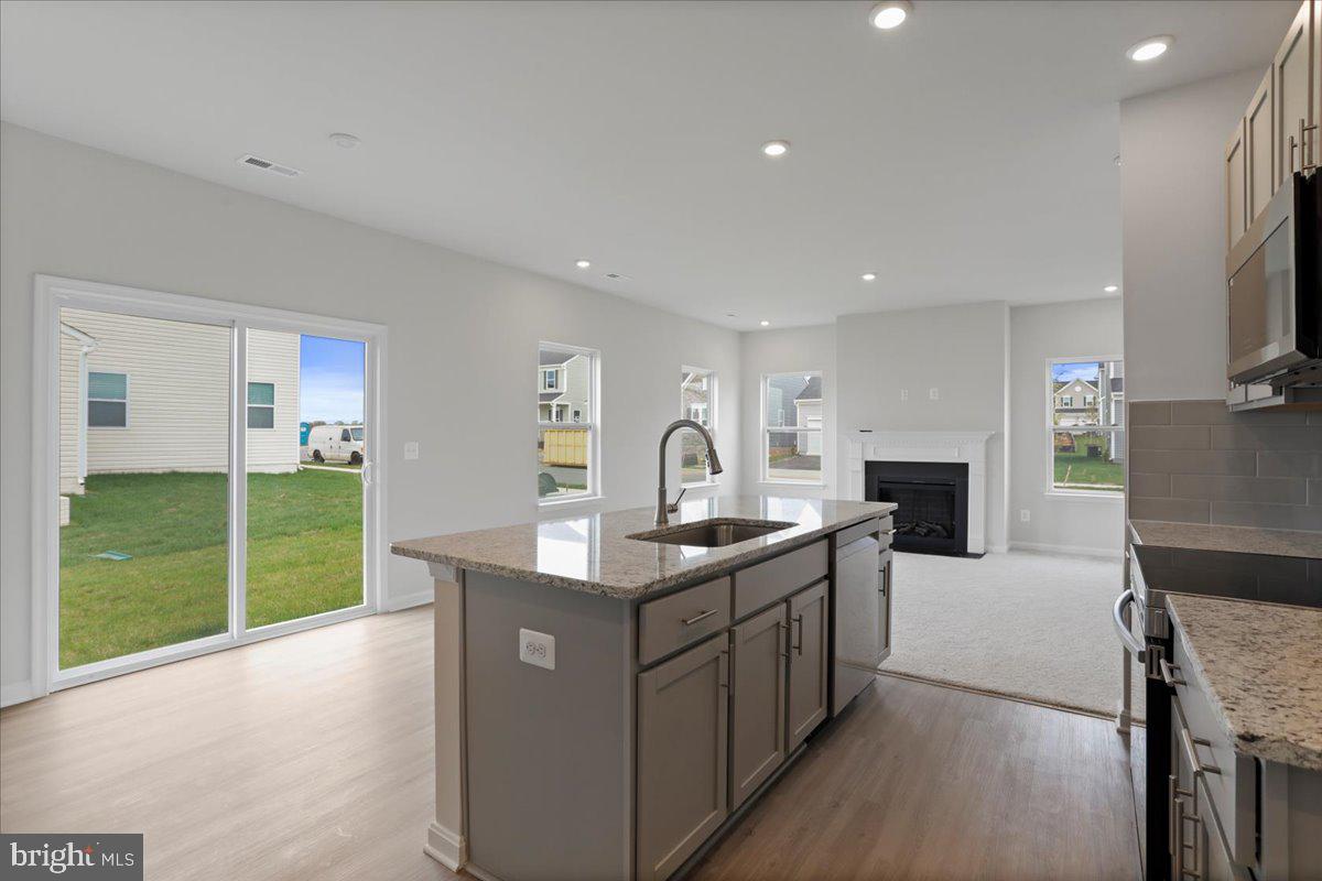 62 Peters Avenue Ranson, WV 25438 - Photo 3 of 31 a kitchen with sink a microwave and refrigerator