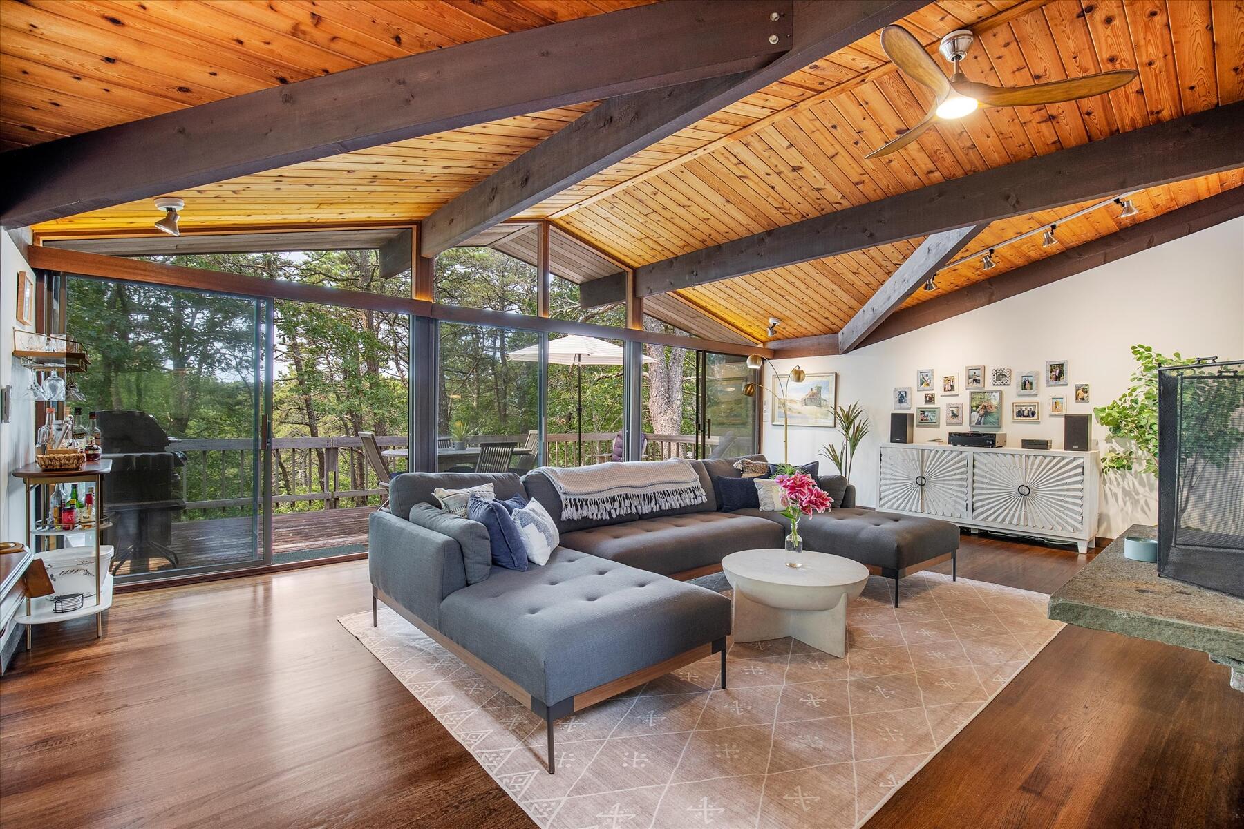 a living room with patio furniture and a floor to ceiling window