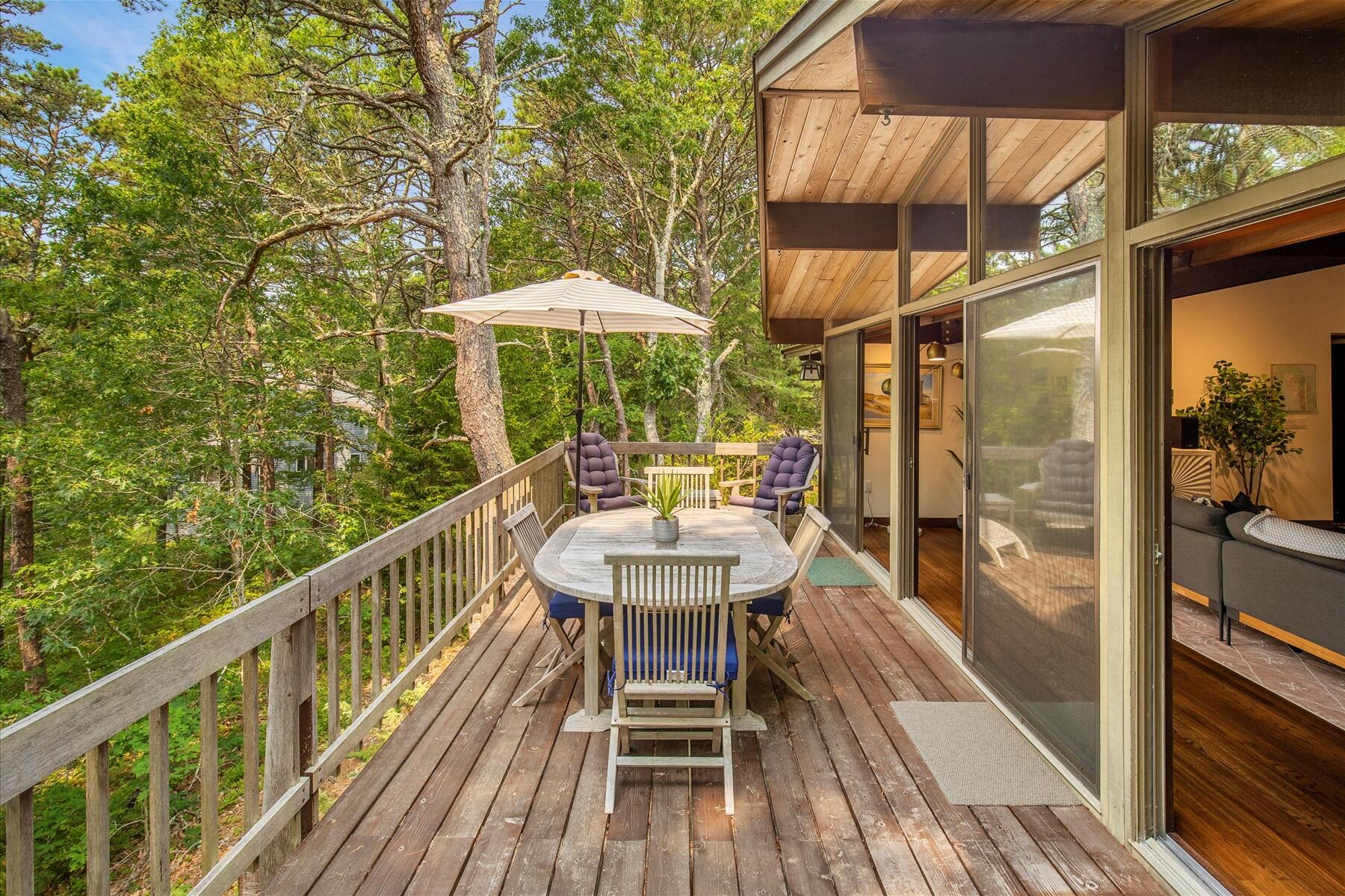 80 Woodlot Road Wellfleet, MA 02667 - Photo 12 of 67 a balcony with table and chairs
