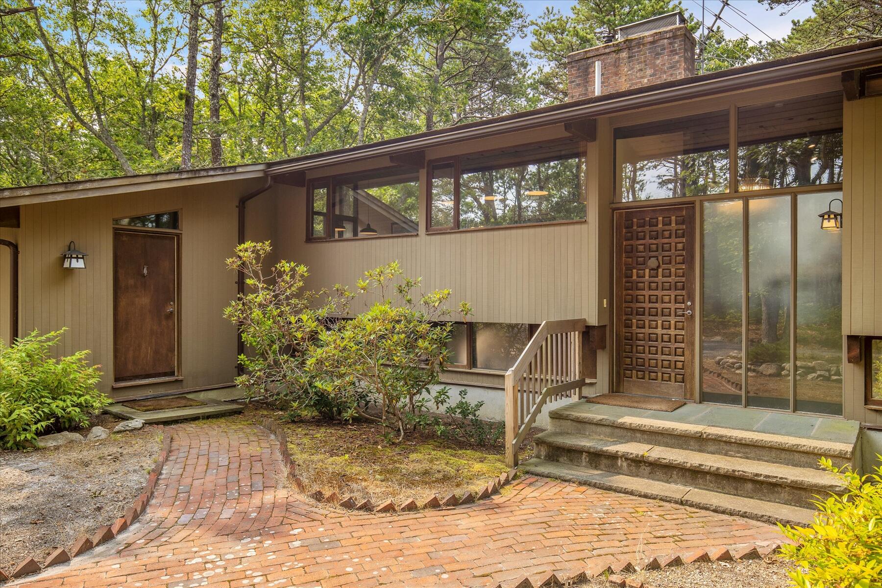 80 Woodlot Road Wellfleet, MA 02667 - Photo 2 of 67 a front view of a house with a yard