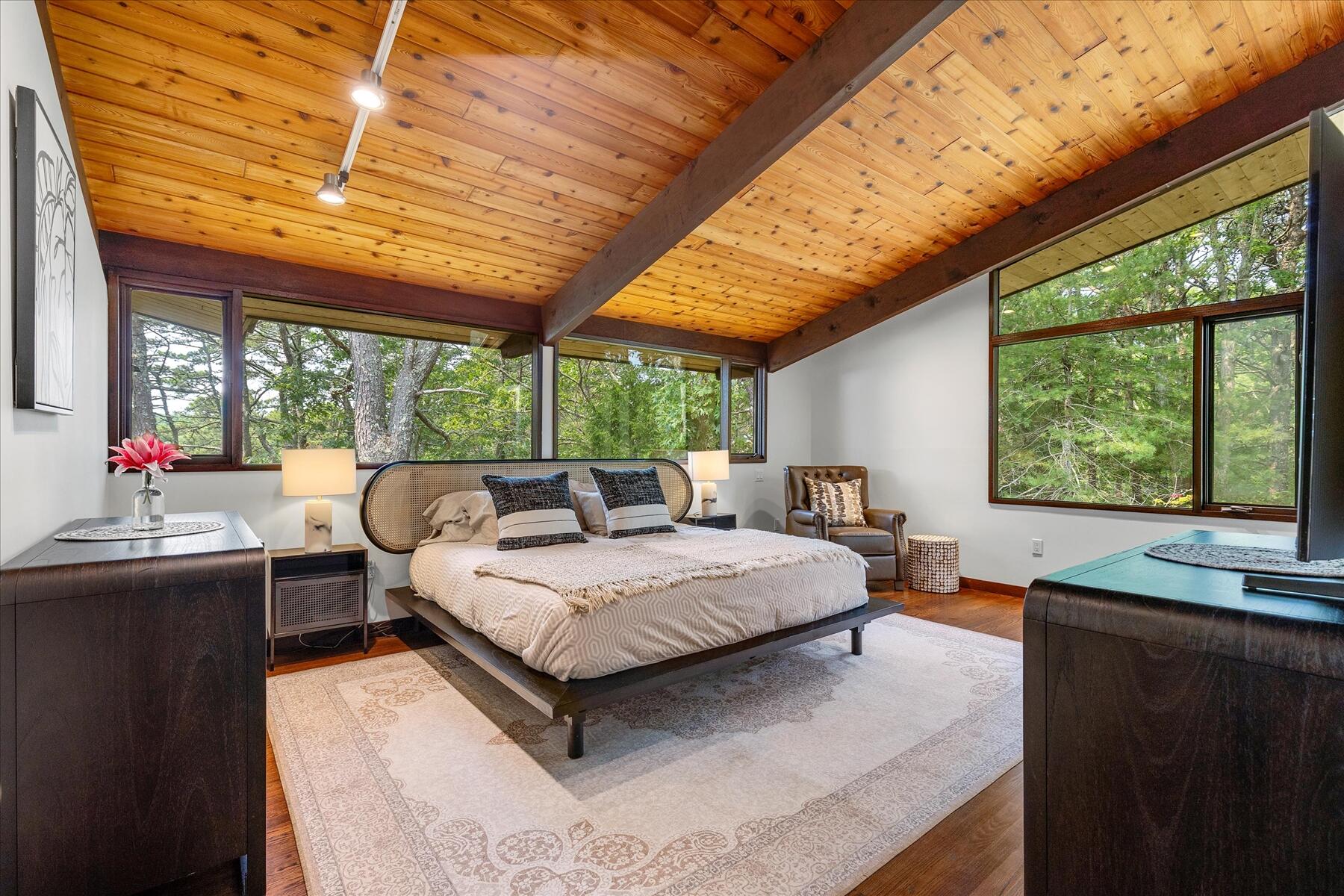 80 Woodlot Road Wellfleet, MA 02667 - Photo 26 of 67 a bedroom with a large bed and a large window