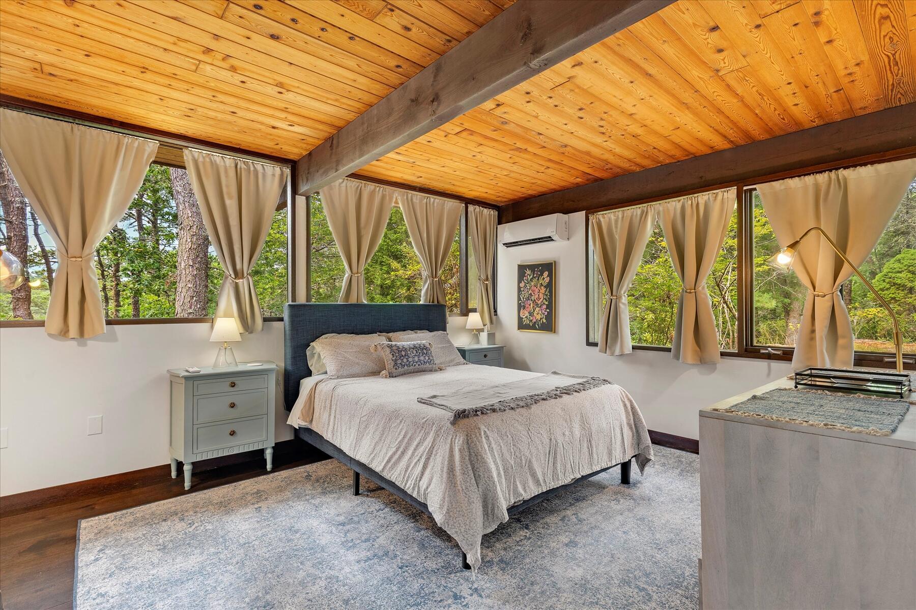 80 Woodlot Road Wellfleet, MA 02667 - Photo 33 of 67 a bedroom with a bed and large windows