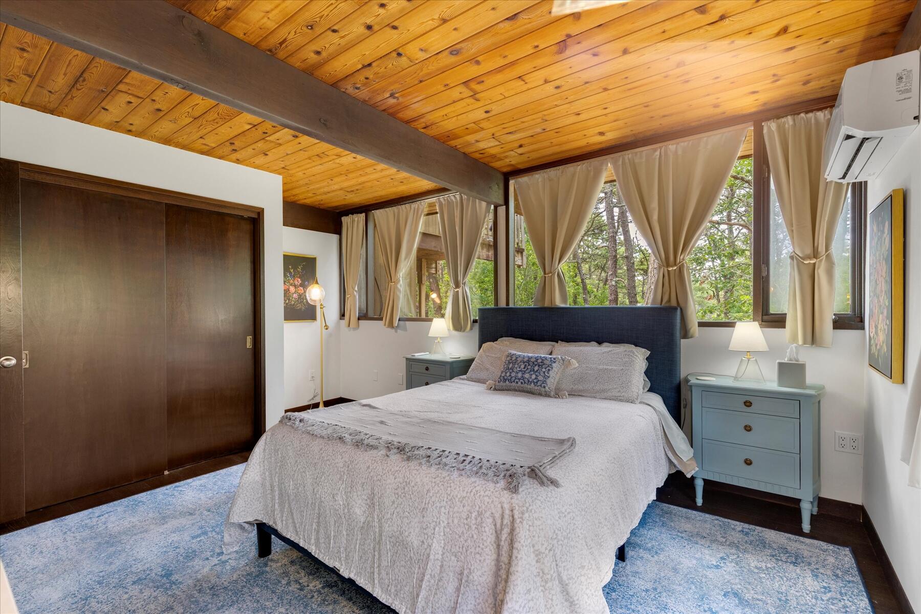 80 Woodlot Road Wellfleet, MA 02667 - Photo 35 of 67 a bedroom with a bed and large windows