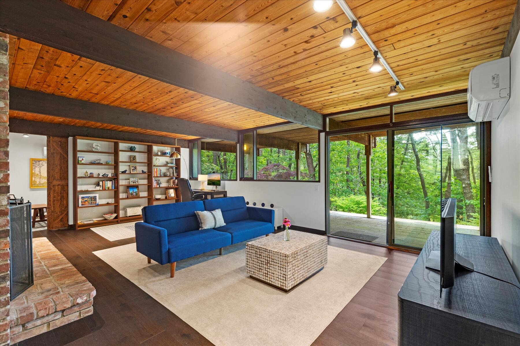 80 Woodlot Road Wellfleet, MA 02667 - Photo 39 of 67 a living room with furniture and a floor to ceiling window