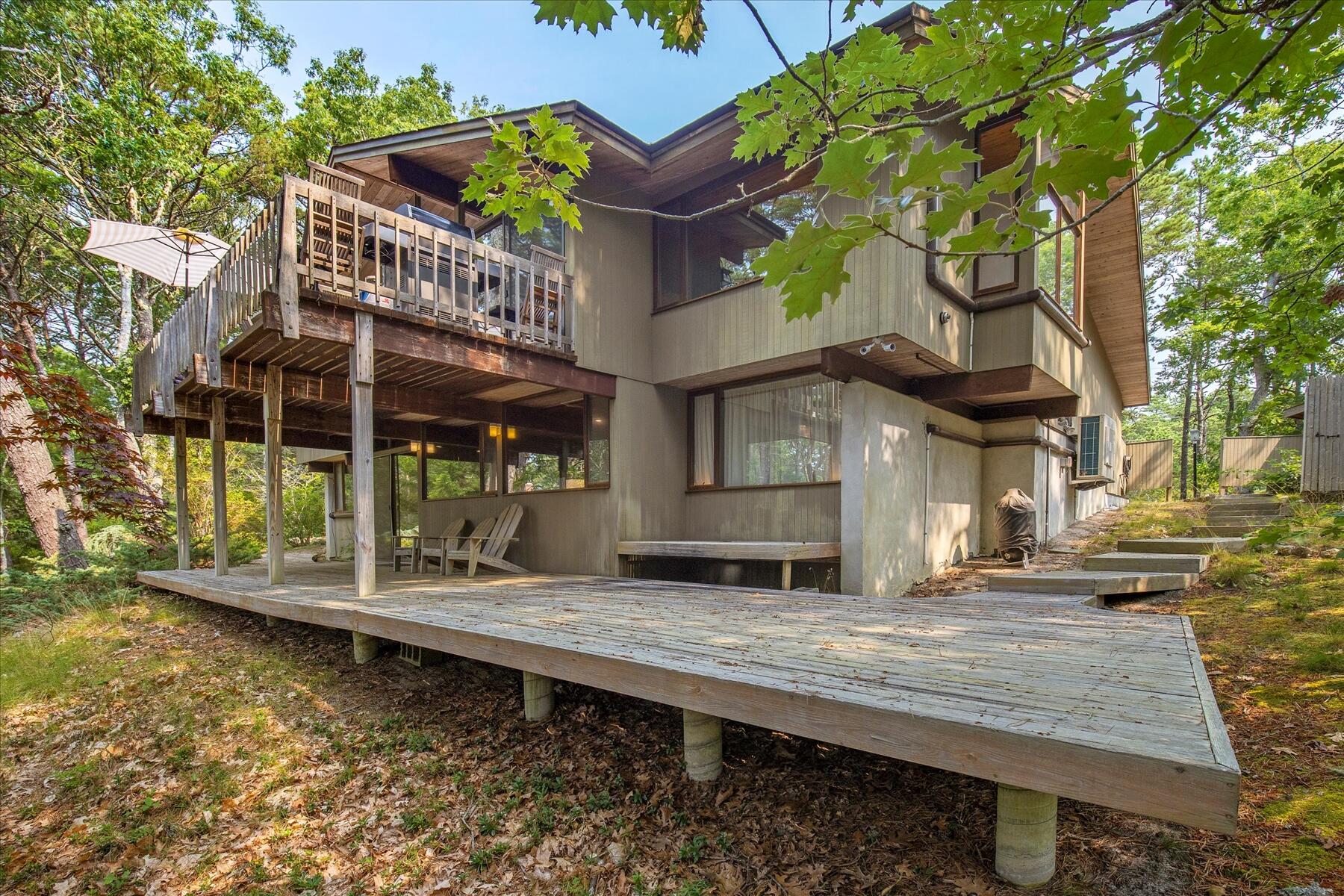 80 Woodlot Road Wellfleet, MA 02667 - Photo 64 of 67 a backyard of a house with barbeque oven table and chairs