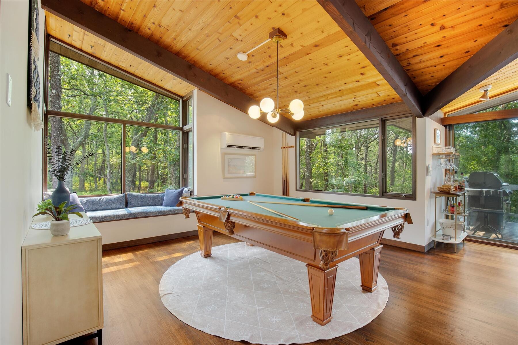 80 Woodlot Road Wellfleet, MA 02667 - Photo 10 of 67 a room with wooden floor pool table and windows