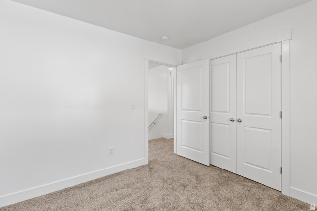 1271 West 500 South Logan, UT 84321 - Photo 22 of 26 Room featuring neutral-toned carpet, white walls, and bright white trim