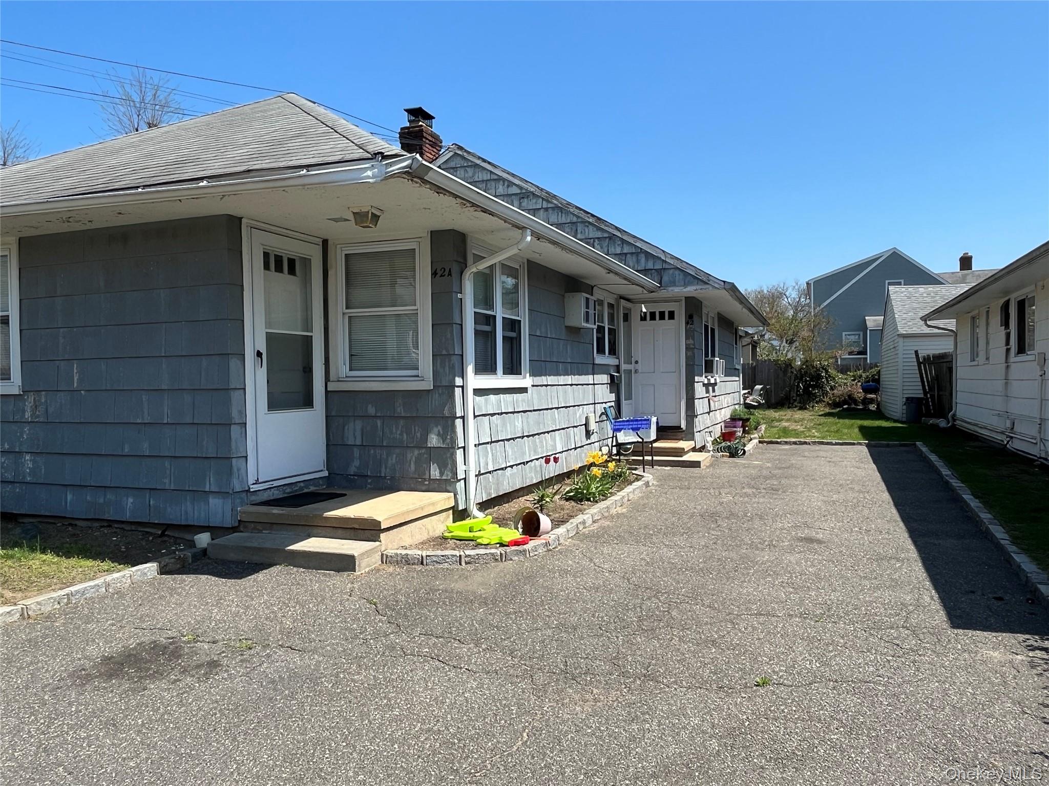 42 Firwood Road Port Washington, NY 11050 - Photo 2 of 3 View of side of home