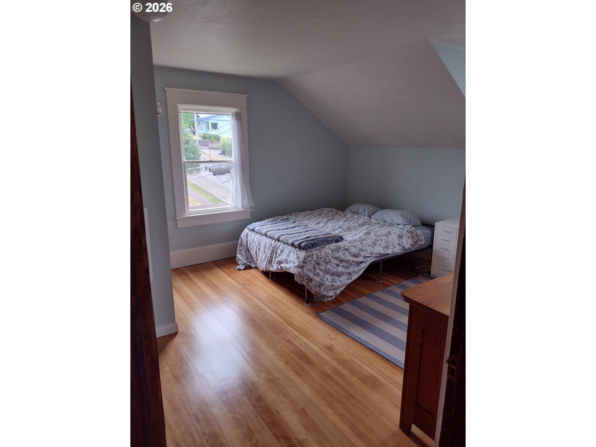612 Harrison Avenue Astoria, OR 97103 - Photo 12 of 17 a bedroom with a bed and a window