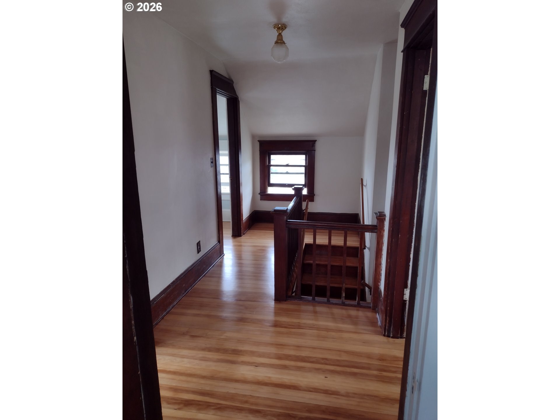 612 Harrison Avenue Astoria, OR 97103 - Photo 7 of 17 a view of a hallway with wooden floor and furniture