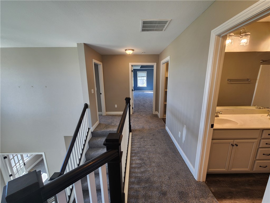 7441 Dodson Road Brookville, OH 45309 - Photo 16 of 50 This spacious landing features plush carpeting and a bright overhead light, creating a welcoming atmosphere.