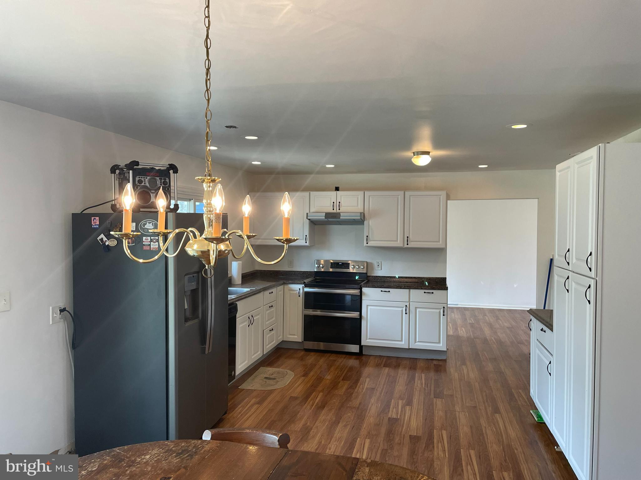 18 Wynn Road Tabernacle, NJ 08088 - Photo 7 of 27 a kitchen with stainless steel appliances granite countertop a refrigerator a stove and a wooden floors