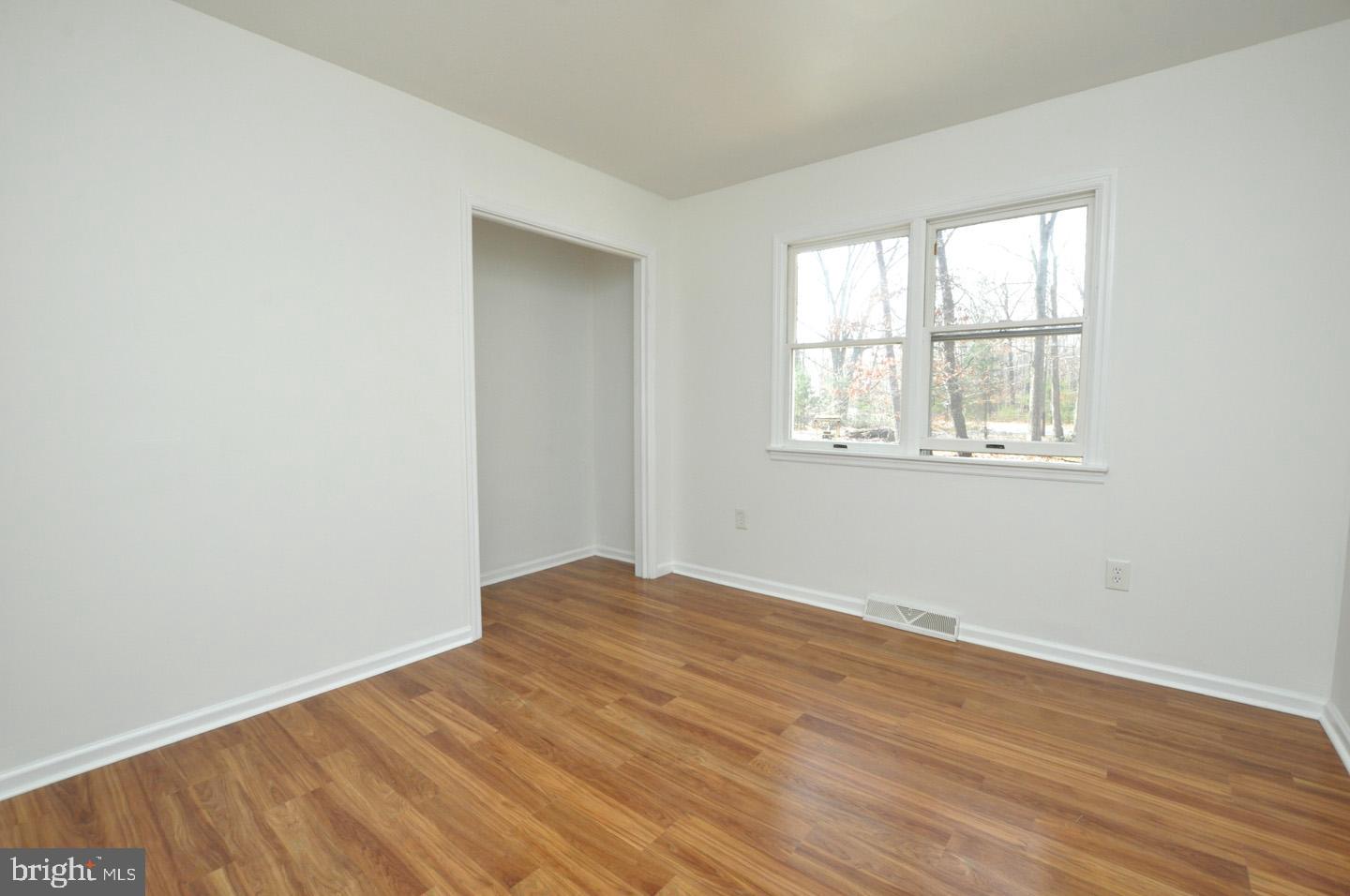 18 Wynn Road Tabernacle, NJ 08088 - Photo 8 of 27 an empty room with wooden floor and windows