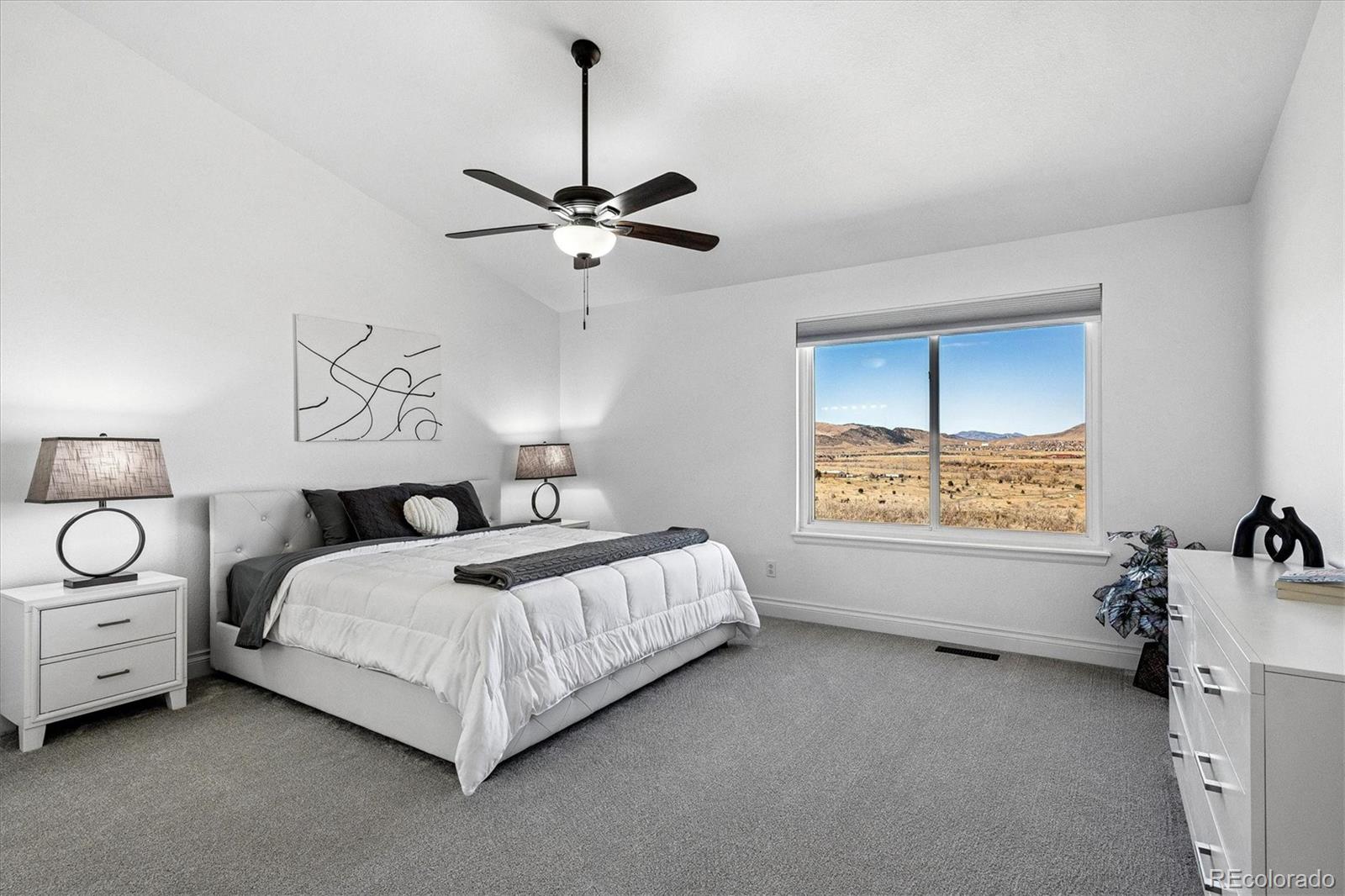 4143 South Deframe Court Morrison, CO 80465 - Photo 30 of 48 a bed room with a bed and a chandelier