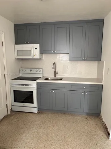 a kitchen with cabinets appliances and a sink