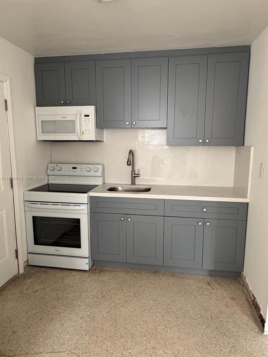 a kitchen with cabinets appliances and a sink