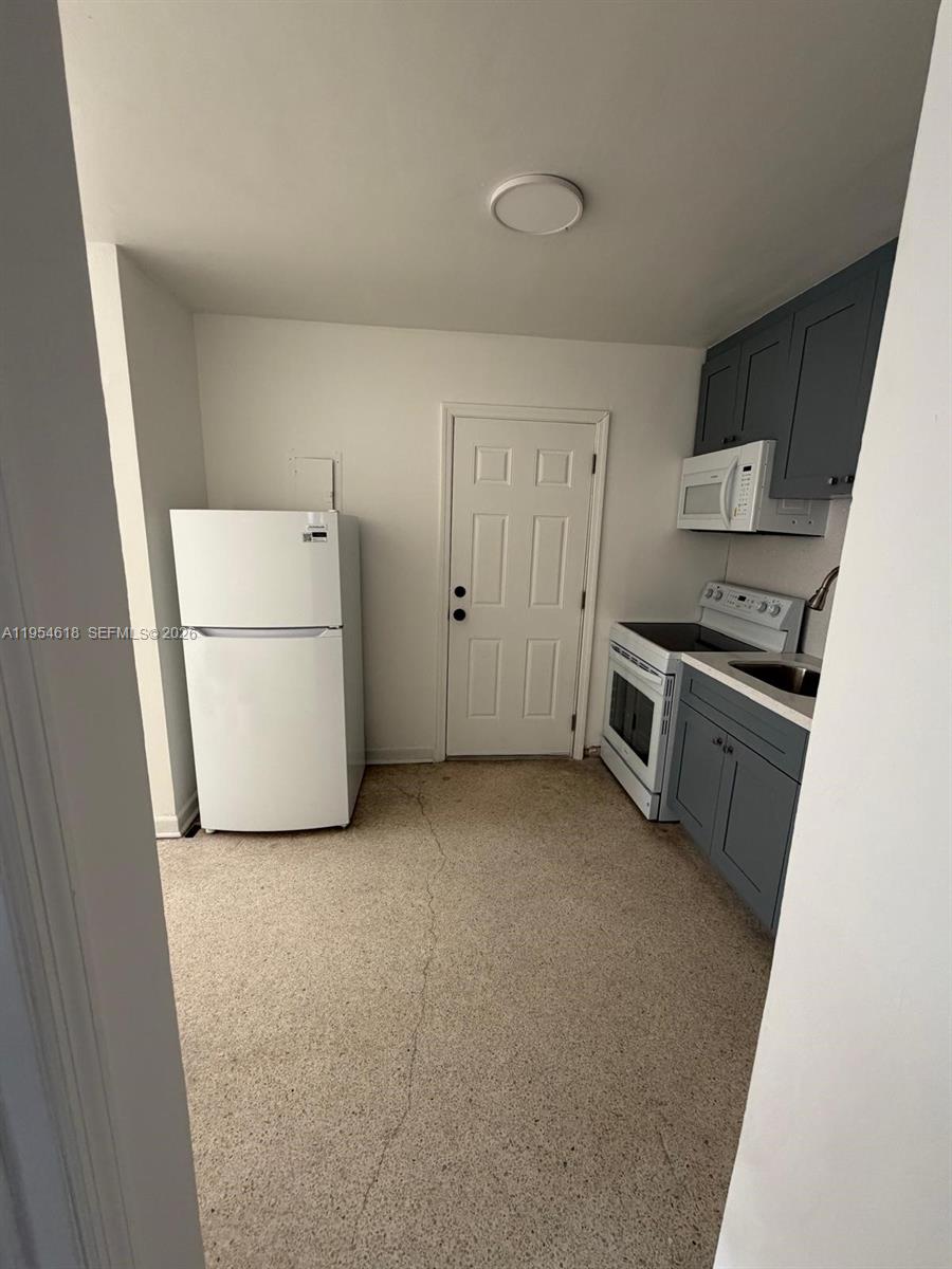 1608 Southwest 4th Street, Unit 9 Miami, FL 33135 - Photo 2 of 7 a view of a kitchen with a sink stove and refrigerator