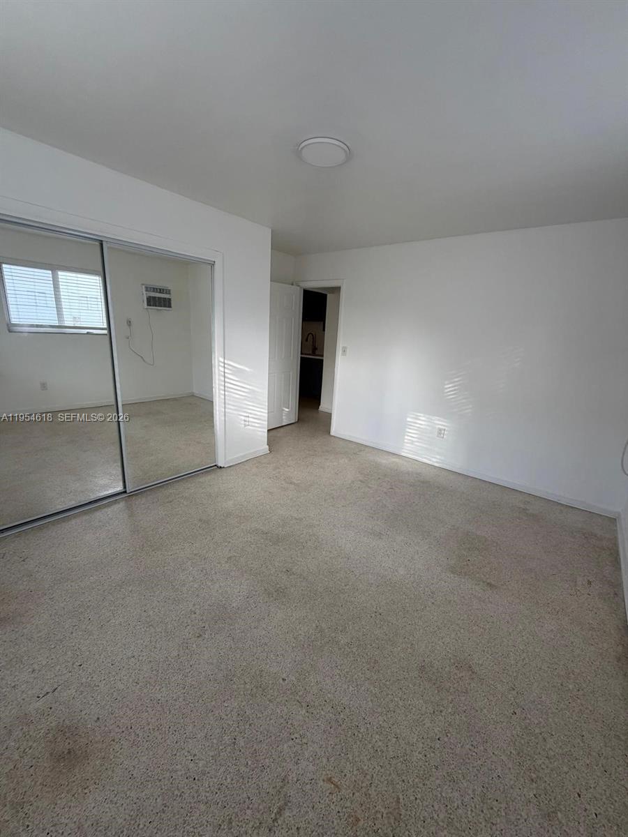 1608 Southwest 4th Street, Unit 9 Miami, FL 33135 - Photo 4 of 7 a view of an empty room with a fireplace