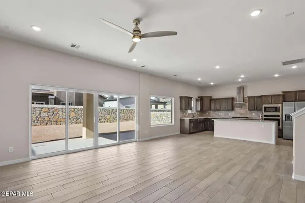 a view of kitchen with stainless steel appliances refrigerator oven and microwave