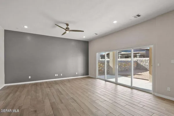 a kitchen with stainless steel appliances granite countertop a refrigerator a sink dishwasher a oven with white cabinets and wooden floor