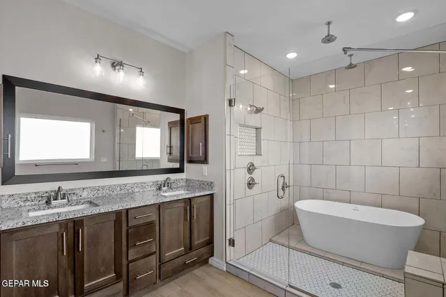 a bathroom with a granite countertop sink and a mirror