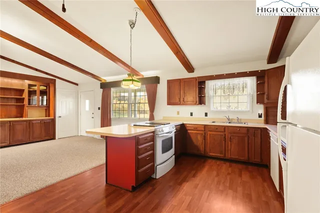 a large kitchen with stainless steel appliances granite countertop a stove and a sink