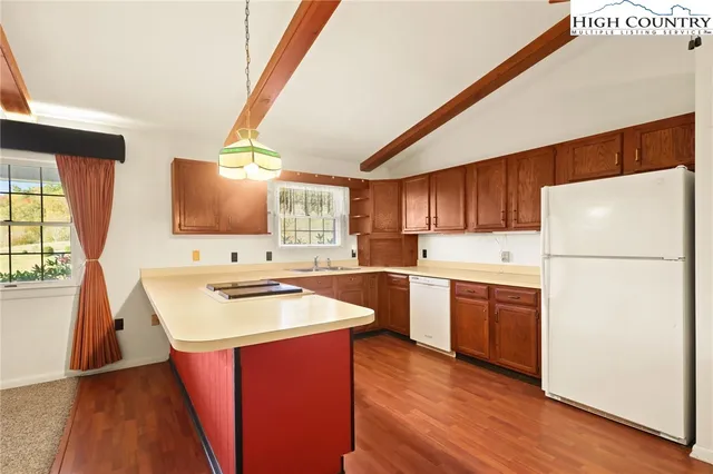 a kitchen with stainless steel appliances a refrigerator stove and sink