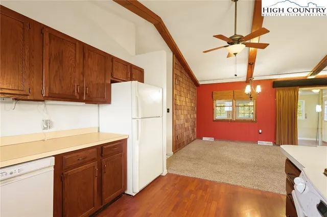 a kitchen with a refrigerator a sink and cabinets