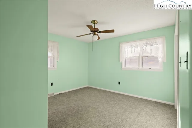 a view of room with window and ceiling fan