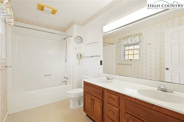 a spacious bathroom with a tub sink shower and mirror