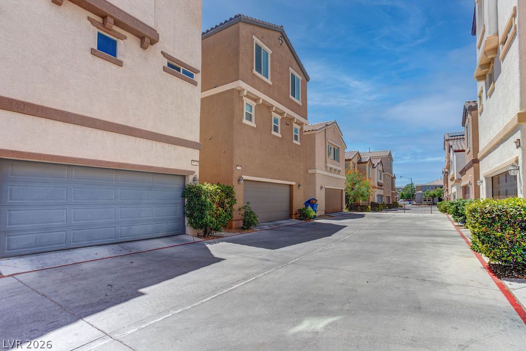 7724 Vibrant Thread Court Las Vegas, NV 89149 - Photo 1 of 43 Rows of contemporary townhomes feature individual garages and landscaped common areas.