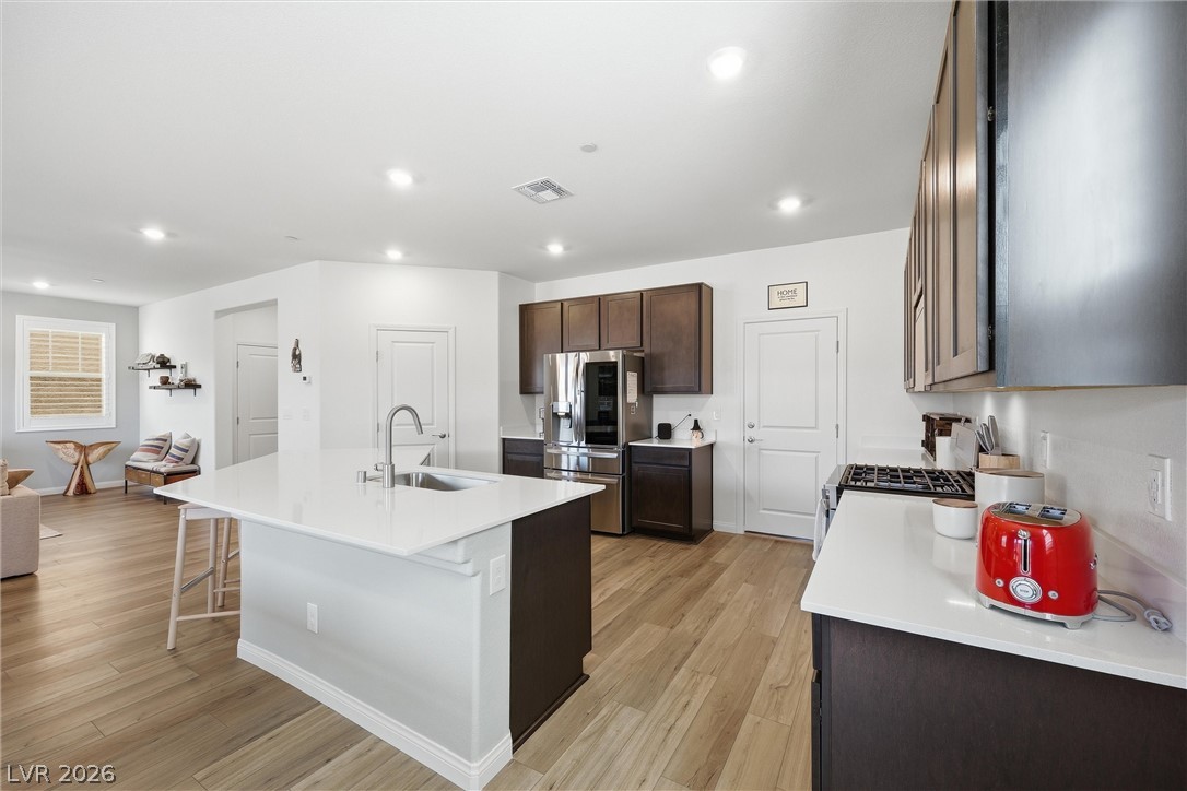 3705 Alla Rocca Avenue Henderson, NV 89044 - Photo 15 of 50 This contemporary kitchen features an island, ample counter space, and modern appliances.