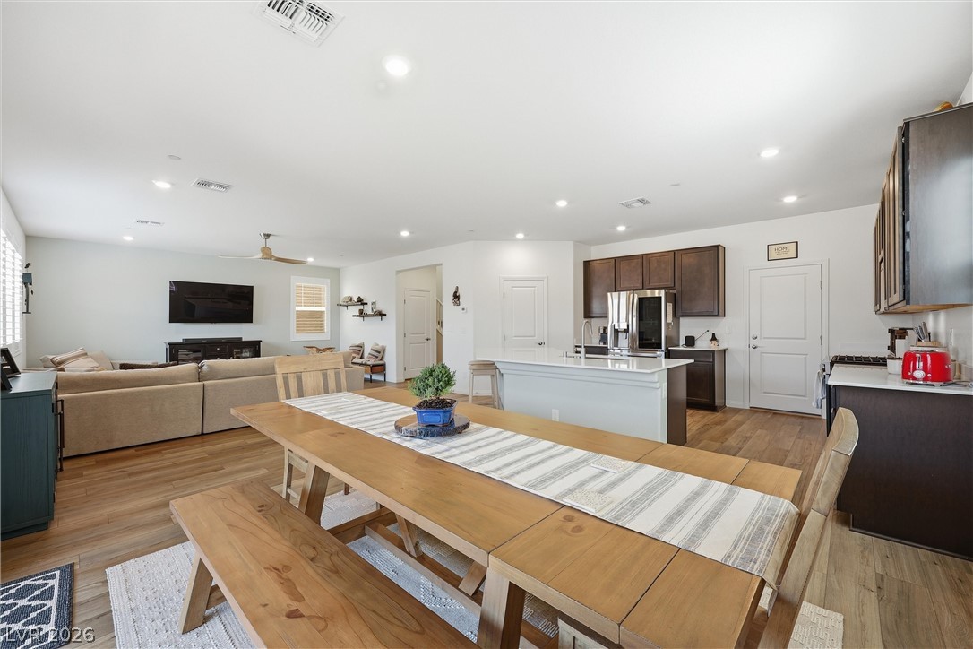 3705 Alla Rocca Avenue Henderson, NV 89044 - Photo 17 of 50 This inviting space seamlessly blends living, dining, and kitchen areas, perfect for modern living.