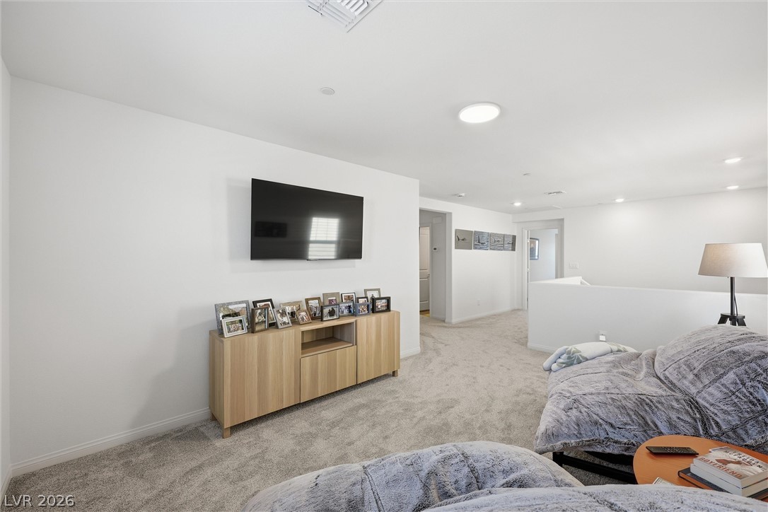 3705 Alla Rocca Avenue Henderson, NV 89044 - Photo 19 of 50 This bright and airy living space features plush carpeting and abundant natural light.