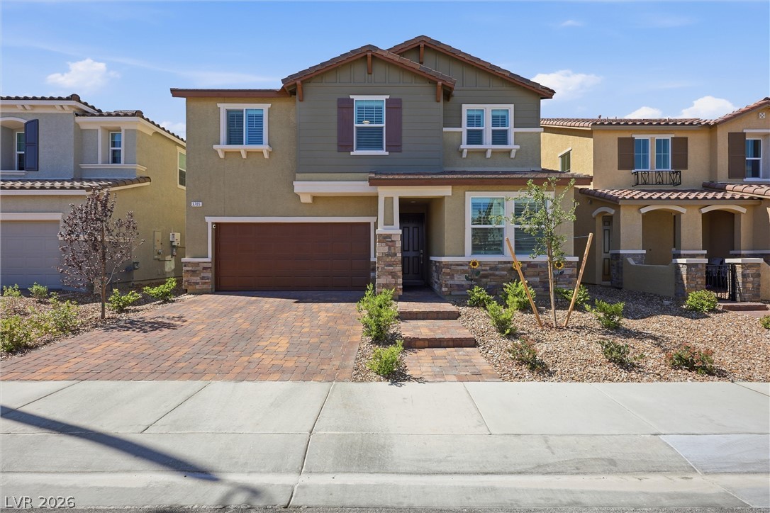 3705 Alla Rocca Avenue Henderson, NV 89044 - Photo 2 of 50 This residence features a paver driveway, an attached garage, and a welcoming front entrance.
