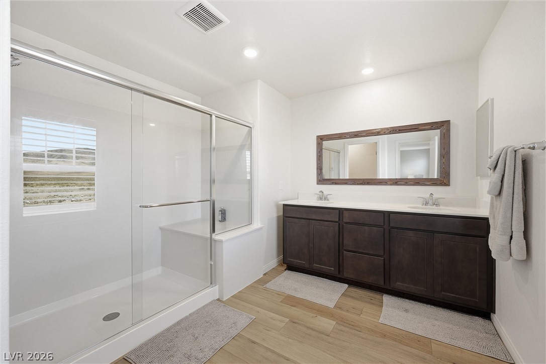 3705 Alla Rocca Avenue Henderson, NV 89044 - Photo 23 of 50 This bright bathroom features a spacious shower and a vanity with double sinks, all with natural light.
