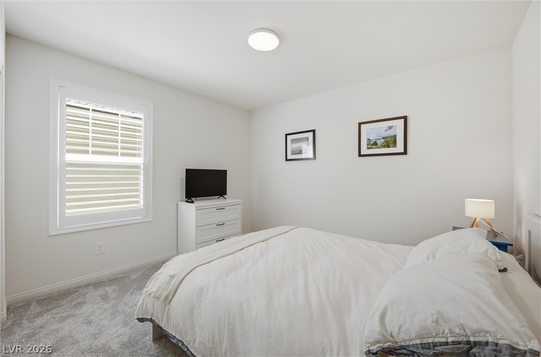 3705 Alla Rocca Avenue Henderson, NV 89044 - Photo 25 of 50 This cozy bedroom #3 offers a tranquil retreat with soft lighting and comfortable carpeting.